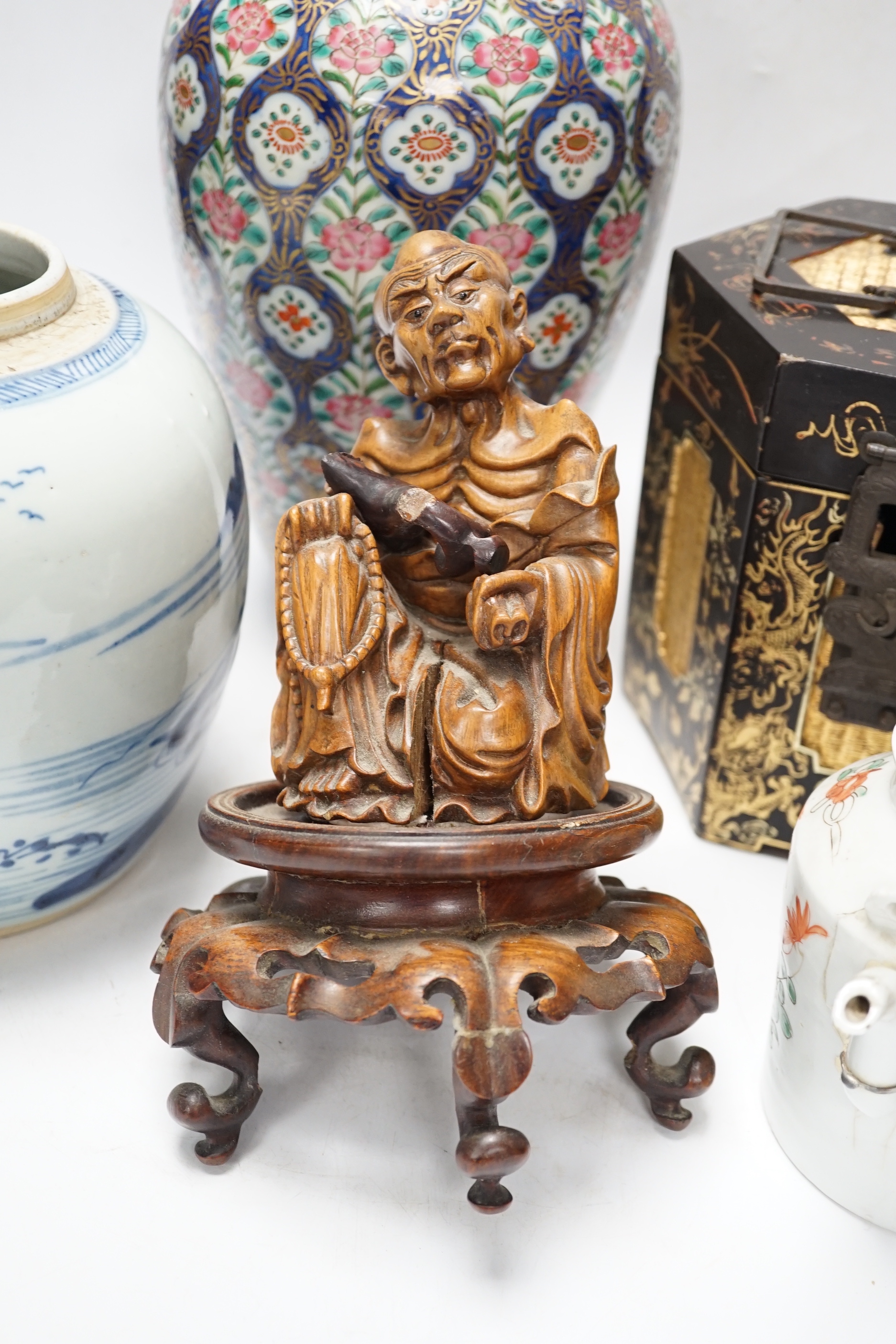 A group of Chinese items including a hardwood carving of luohan, an 18th century blue and white jar, a lacquer box, etc.